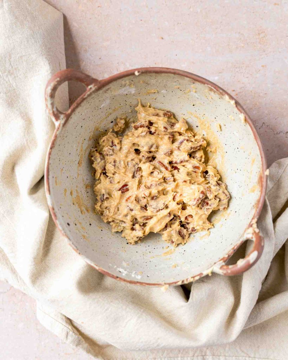 A small bowl filled with the pecan topping ingredients that have been mixtured until creamy. Hostess At Heart