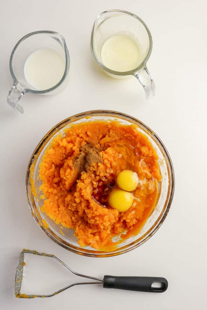 Creamy sweet potato casserole filling mixed with eggs, butter, and cinnamon in a bowl - Hostess At Heart
