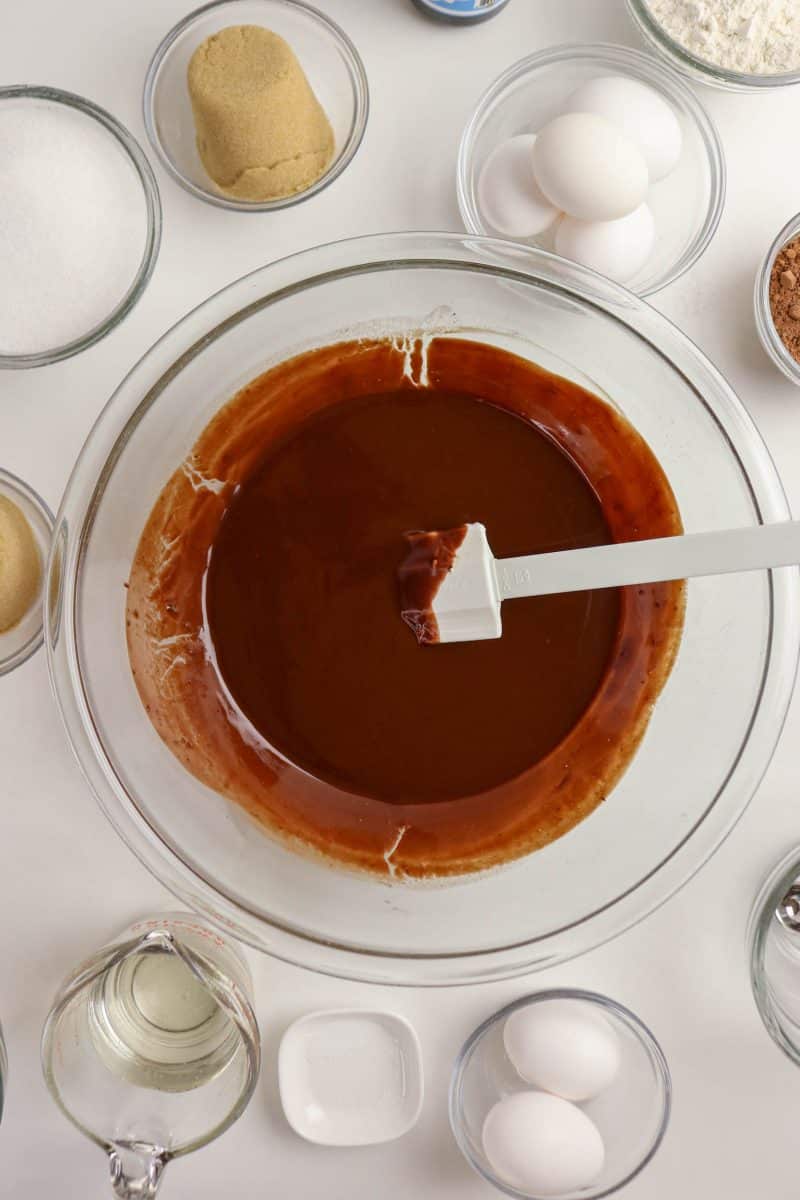 Melted chocolate and butter mixed together in a mixing bowl until smooth and glossy - Hostess At Heart