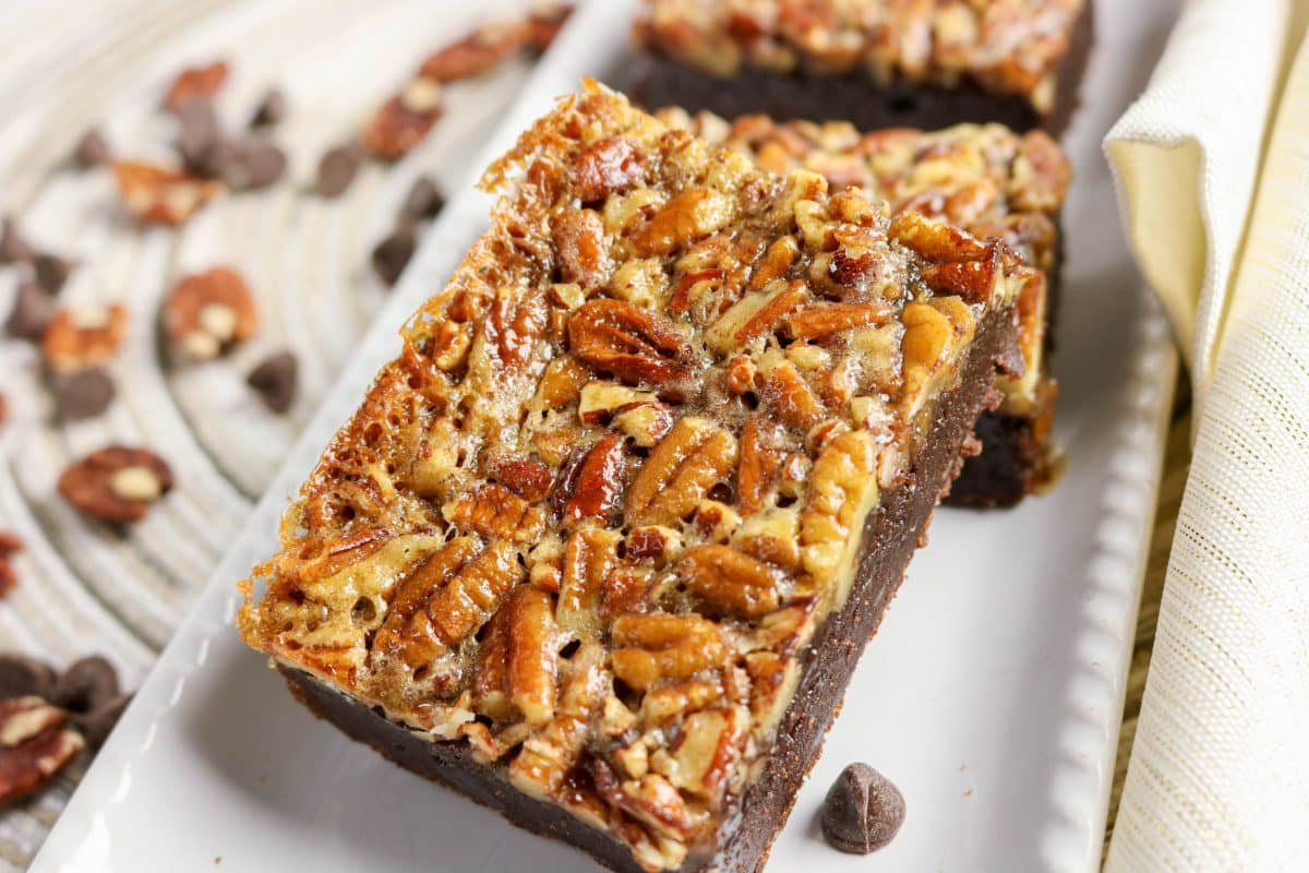 Stack of two pecan pie brownies showing thick fudgy layers and pecans - Hostess At Heart