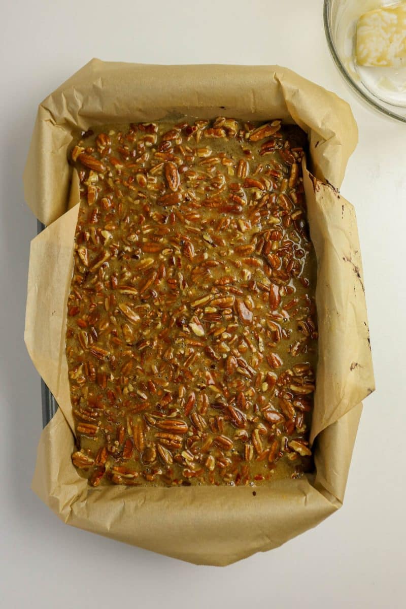 Fully baked pecan pie brownies with golden set topping fresh from oven - Hostess At Heart