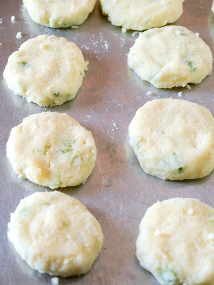Front view of R\raw potato cake patties on baking sheet before baking - Hostess At Heart
