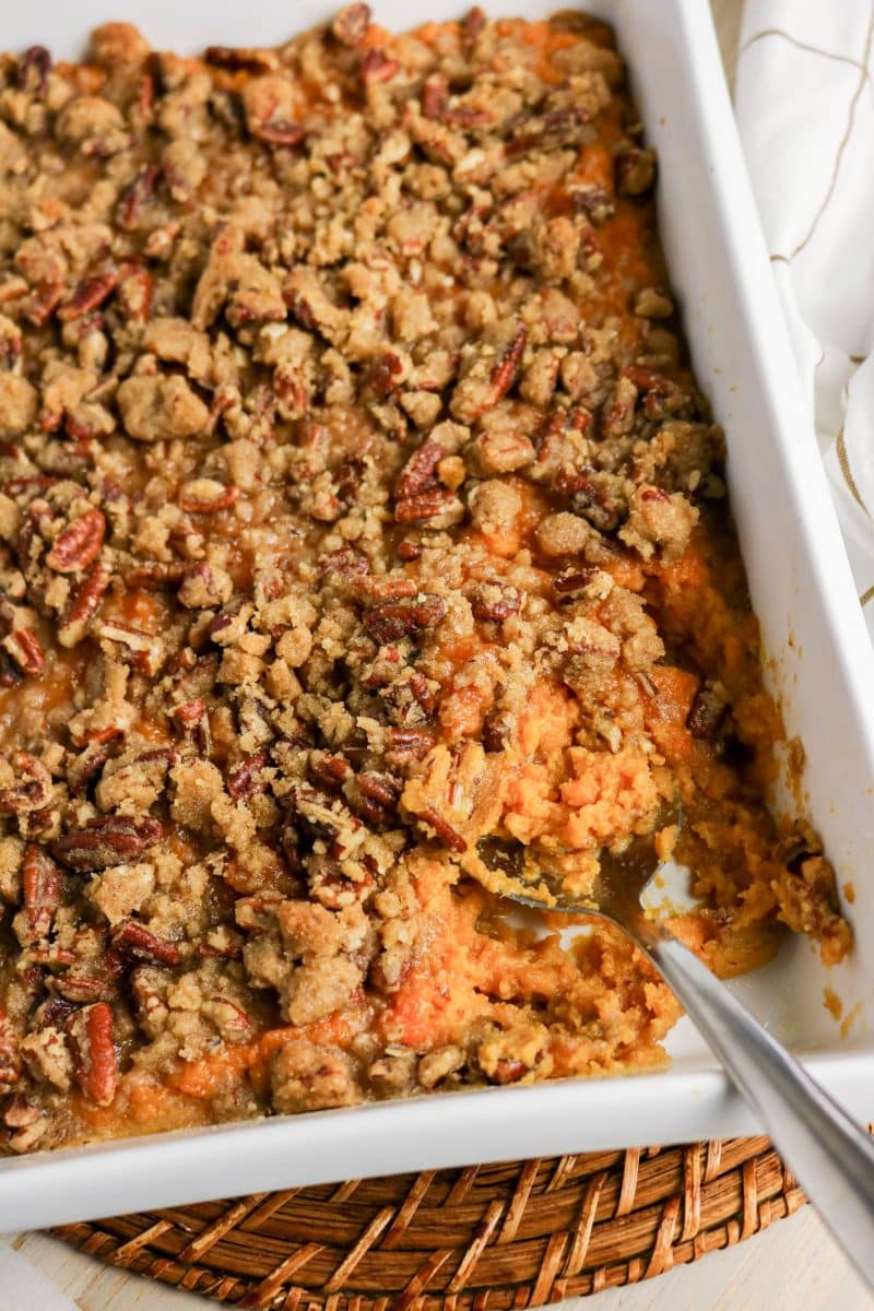 Close up of sweet potato casserole showing creamy filling and crunchy pecan topping - Hostess At Heart
