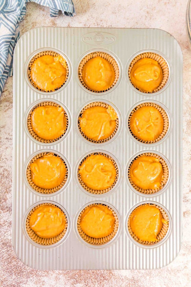 Filled muffin pan with sourdough pumpkin muffin batter - Hostess At Heart