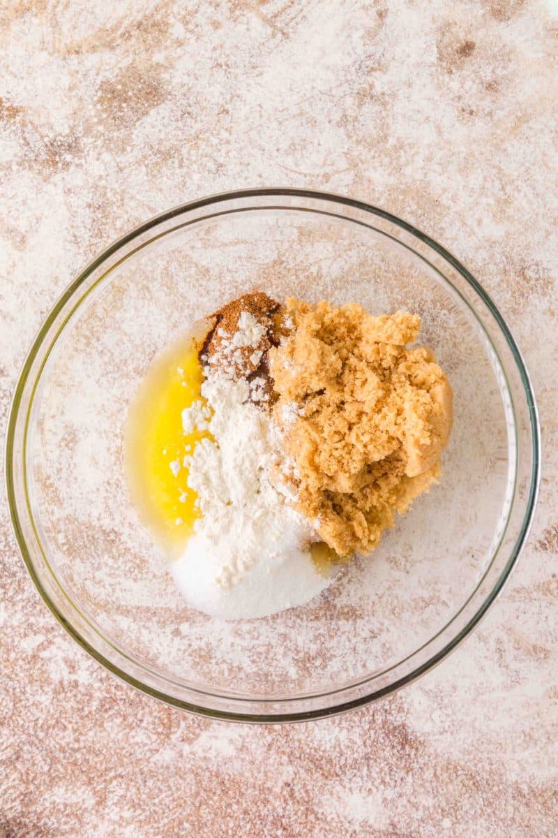 Mixing melted butter with flour, brown sugar, and pumpkin spice to make crumble topping - Hostess At Heart