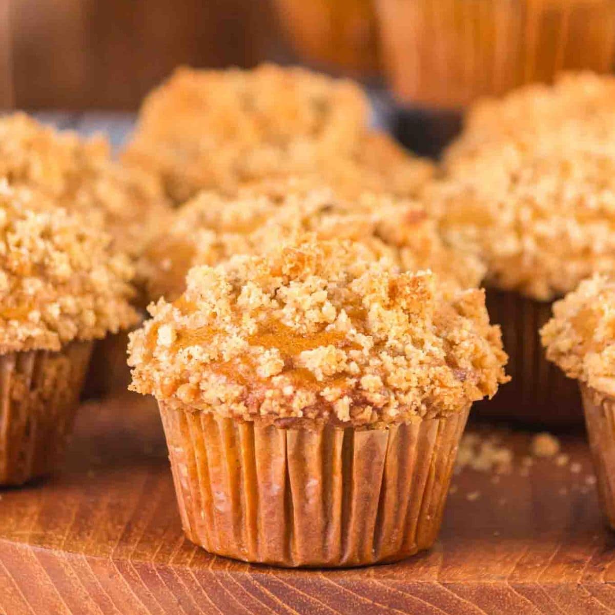 Close up of a sourdough pumpkin muffin with crumble topping showing moist texture and tall bakery-style dome - Hostess At Heart
