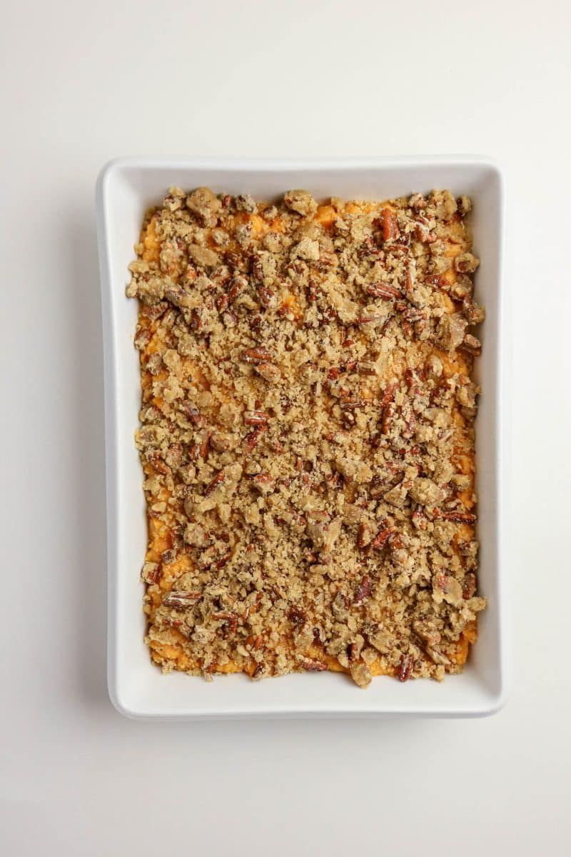 Unbaked sweet potato casserole with pecan topping ready to go in the oven - Hostess At Heart