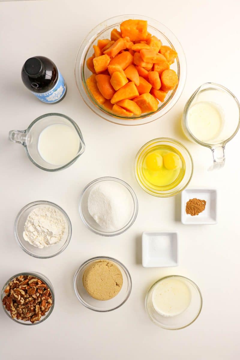 Ingredients for Sweet Potato Casserole made from canned yams: pecans, brown sugar, milk, canned yams, cinnamon, eggs, vanilla, sugar, and salt - Hostess At Heart