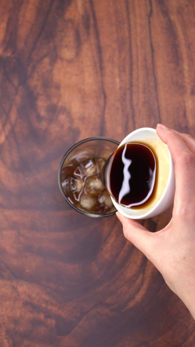 Pouring a chocolate liqueur into a glass of ice and espresso coffee - Hostess At Heart