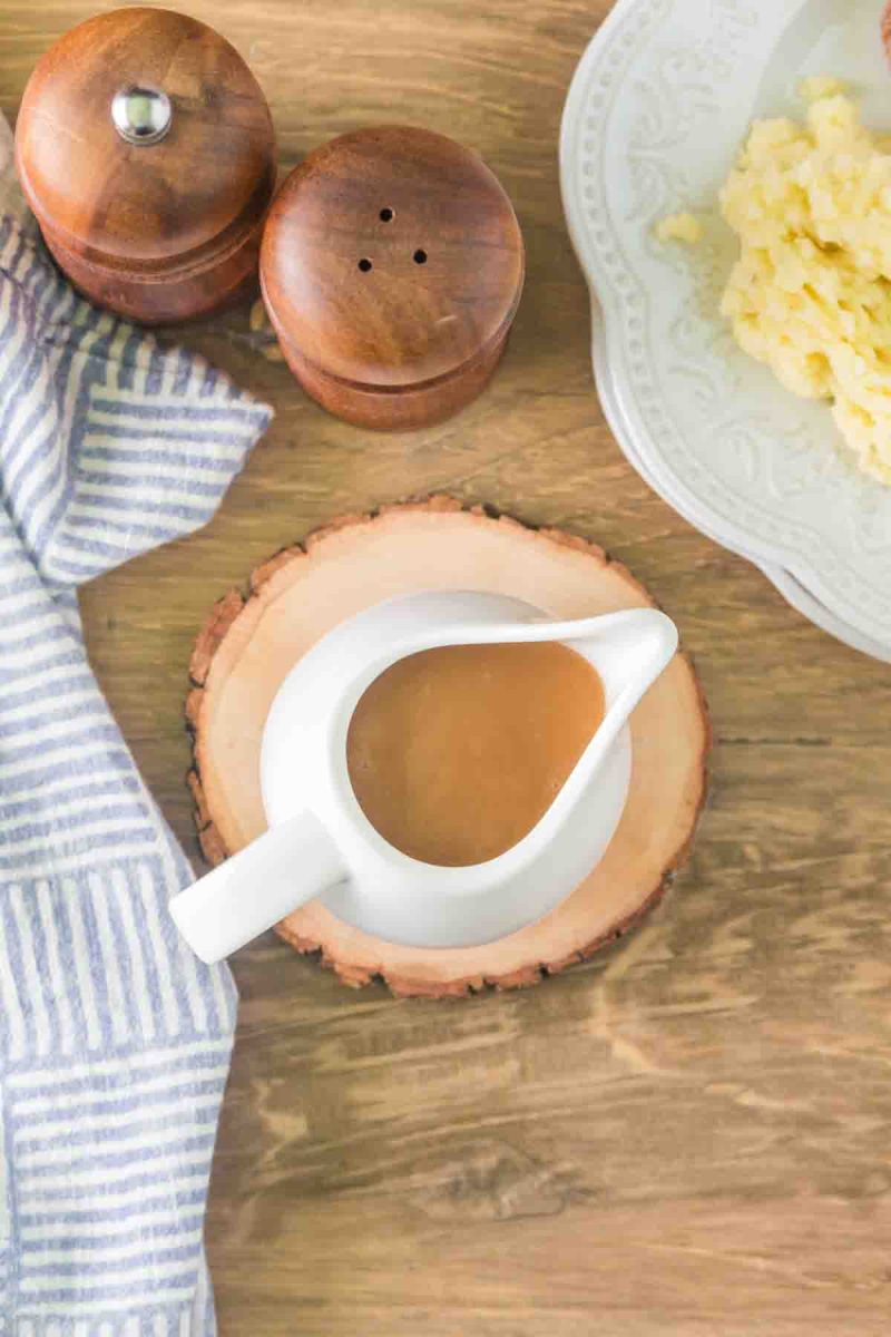 Top down view of smooth beef gravy in white gravy boat ready to serve - Hostess At Heart
