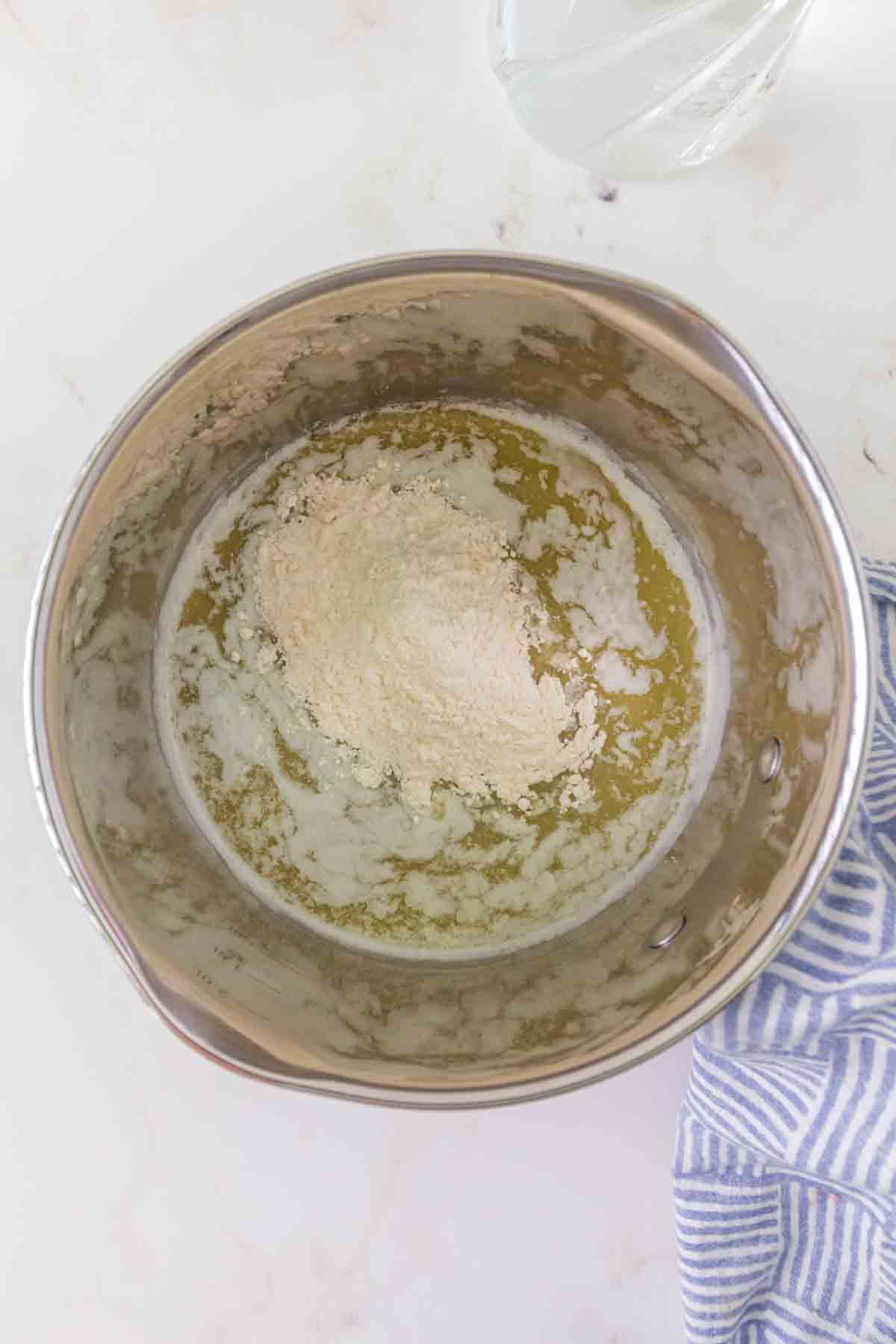 Flour added to melted butter to make roux for beef broth gravy - Hostess At Heart