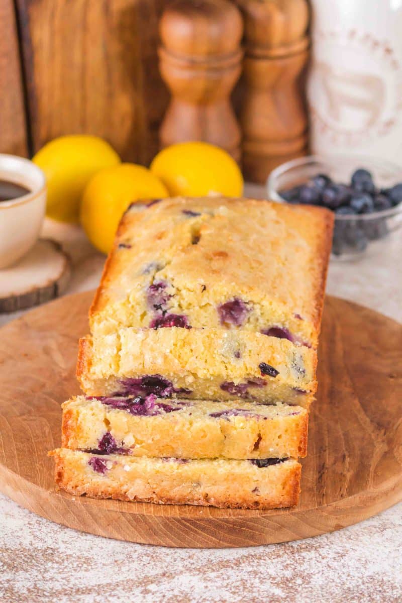a loaf of lemon blueberry sourdough bread with the front slices fanned out showing texture. Hostess At Heart