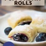 An image for Pinterest of a front view of blueberry filled puff pastries sitting on a white plate - Hostess At Heart