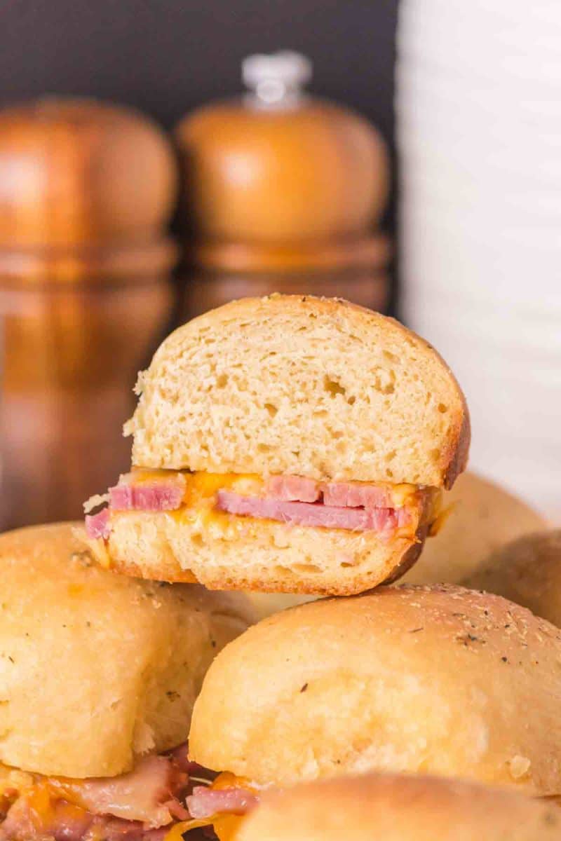Cross-section view of Hawaiian ham and cheese sliders showing all layers. Hostess At Heart