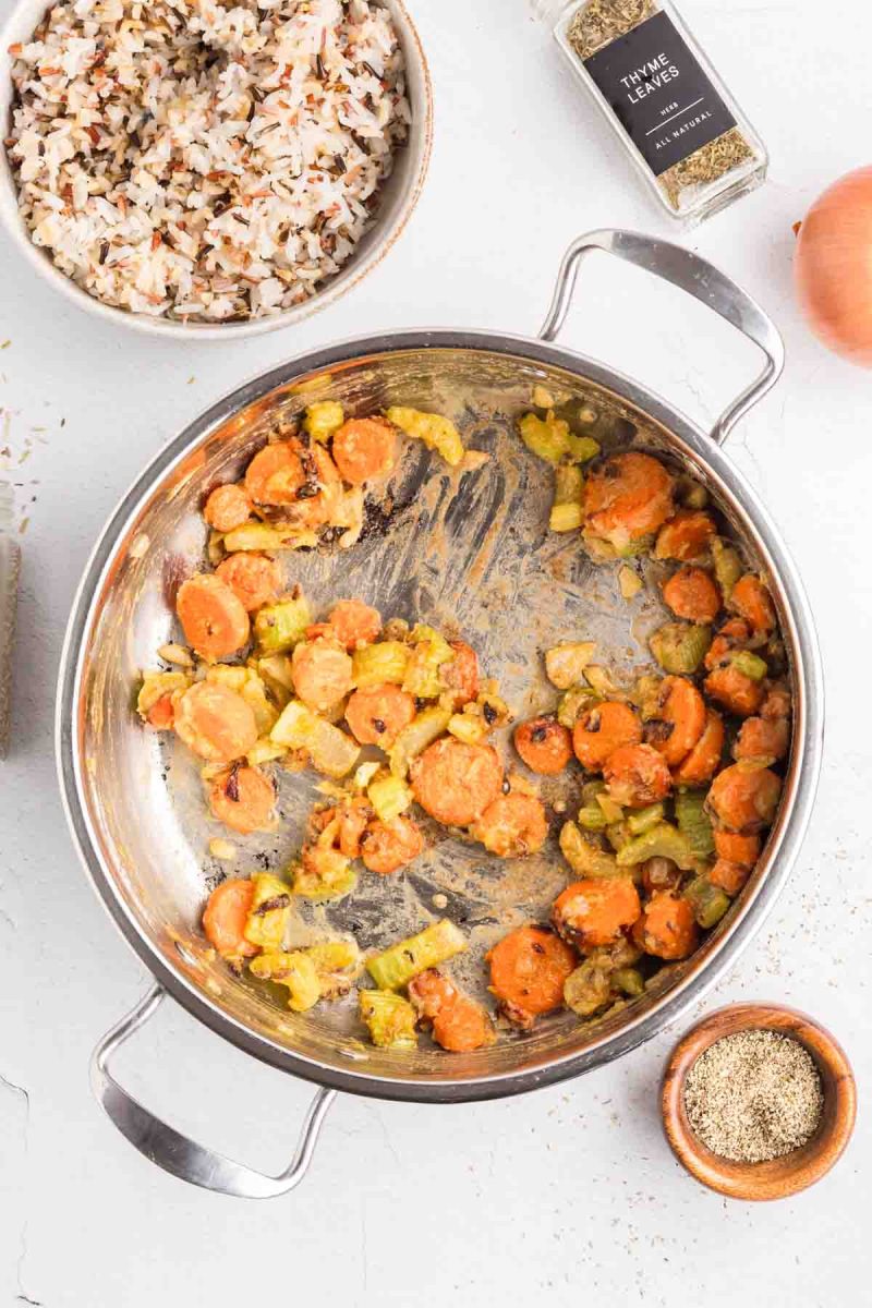 A pot showing a thickened roux and sauteed vegetables to make a one-pot chicken soup with rice. Hostess At Heart