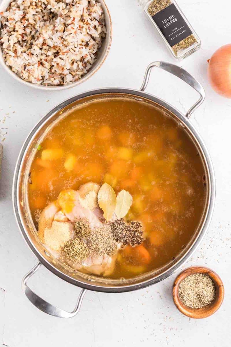 Top down view of a soup pot filled with a thickened broth filled with sauteed veggies. Hostess At Heart