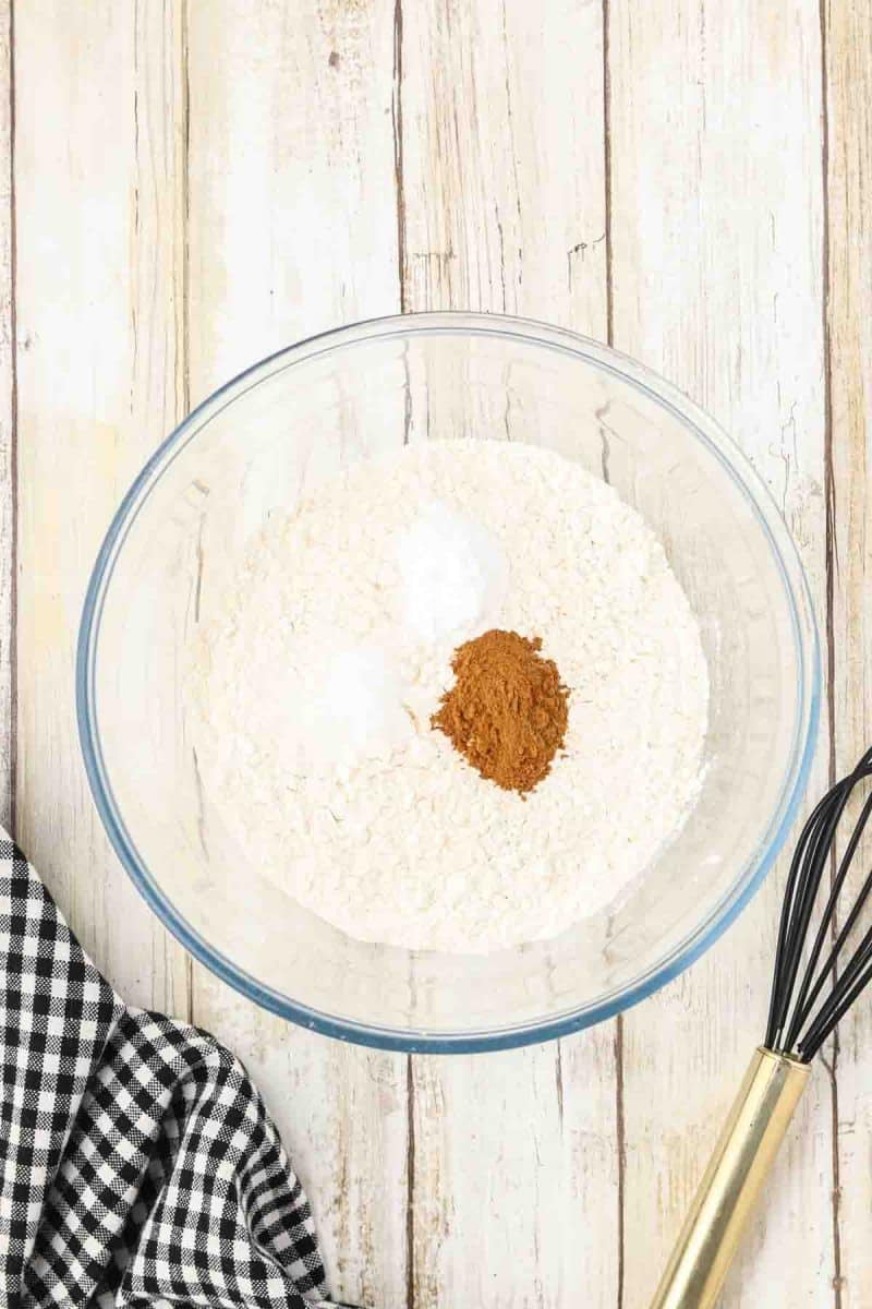 Cowboy Cookie Recipe dry ingredients in a mixing bowl including flour, cinnamon, baking soda, and salt. Hostess At Heart