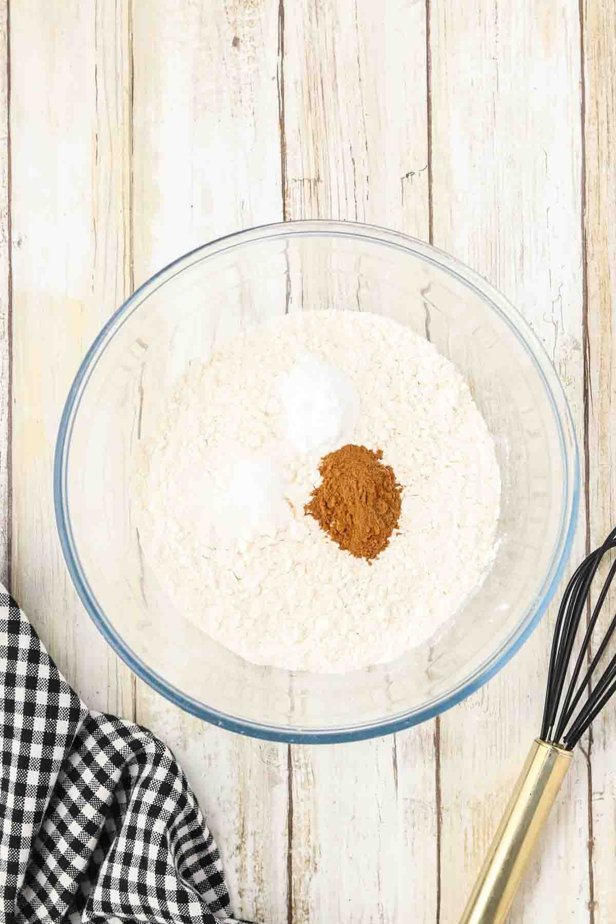 Cowboy Cookie Recipe dry ingredients in a mixing bowl including flour, cinnamon, baking soda, and salt. Hostess At Heart