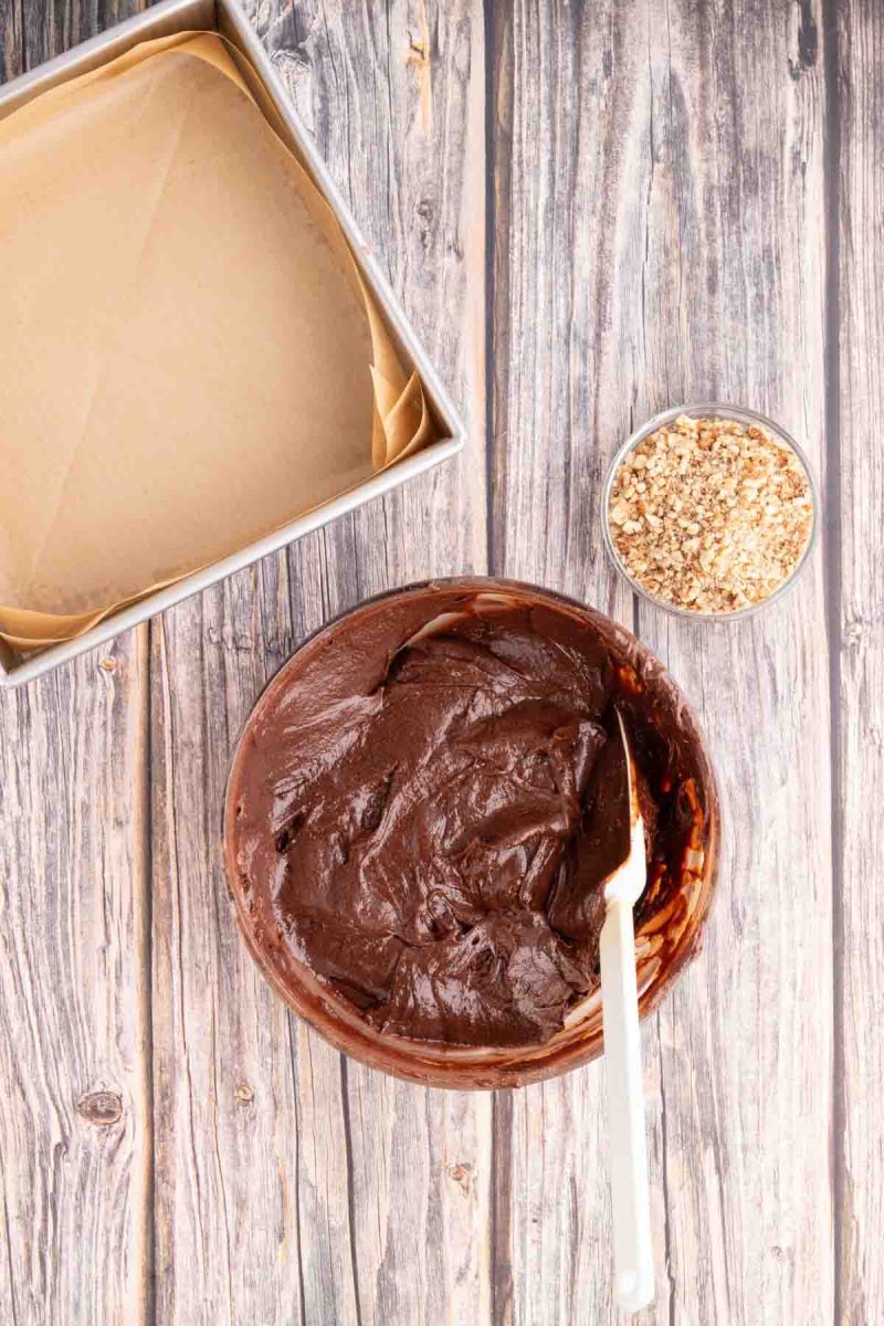 A bowl of creamy brownie batter made from pitted dates, melted chocolate, vanilla and eggs. Hostess At Heart