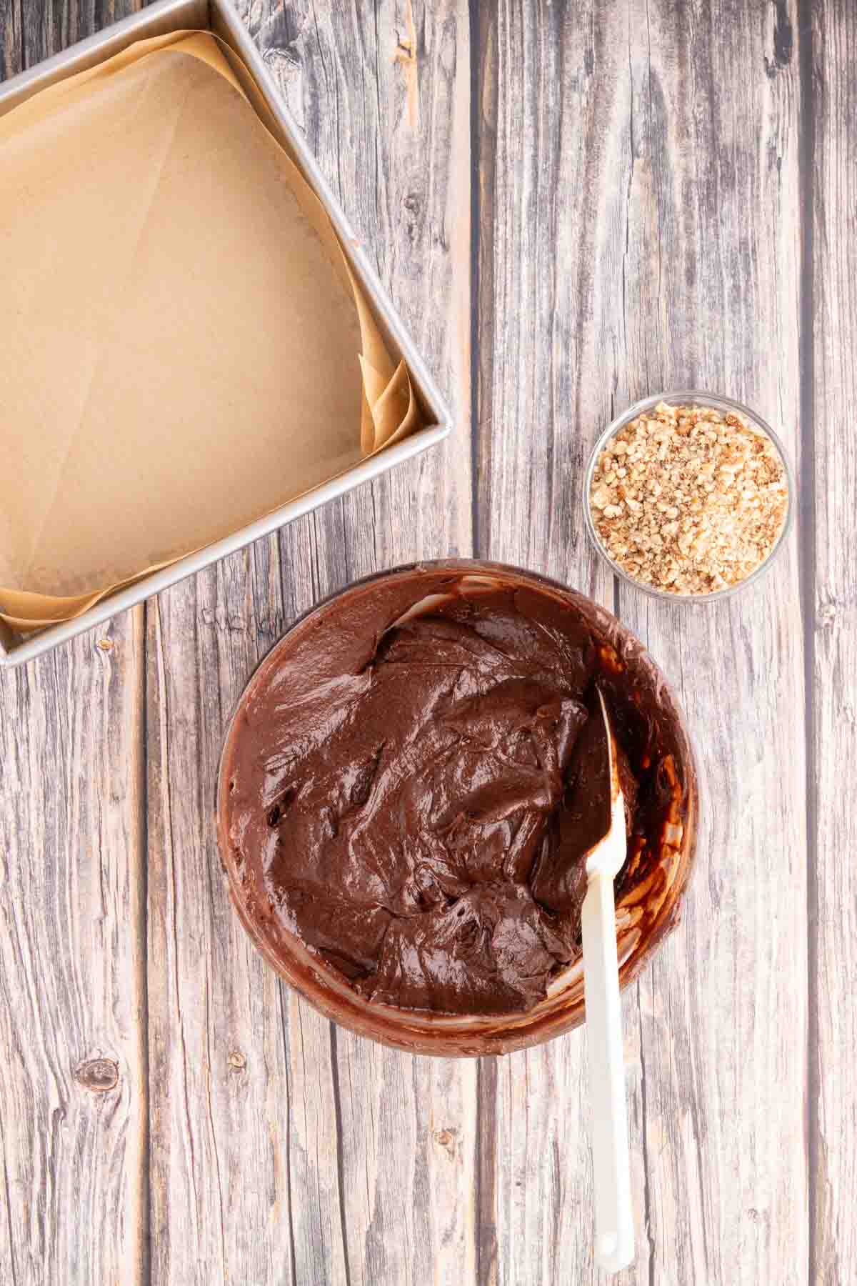 A bowl of creamy brownie batter made from pitted dates, melted chocolate, vanilla and eggs. Hostess At Heart