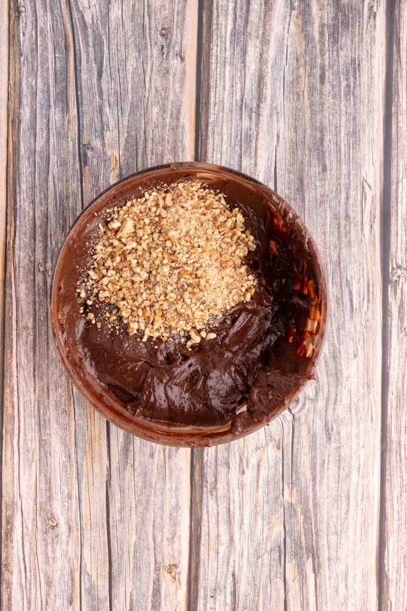 Crushed pecans added to smooth brownie batter made from blended dates and eggs. Hostess At Heart