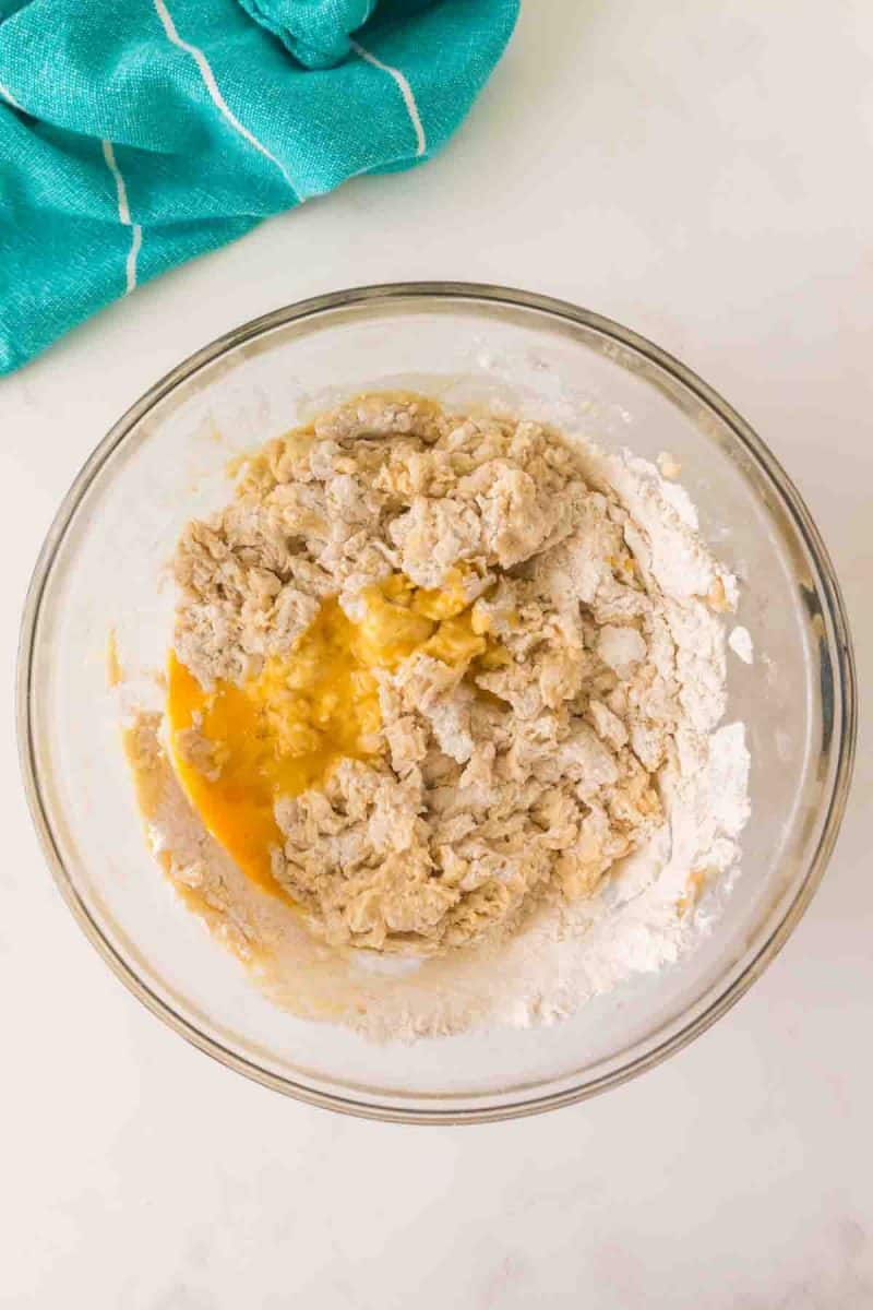 Egg and pineapple juice mixture added to Hawaiian bread dough in a mixing dough - Hostess At Heart