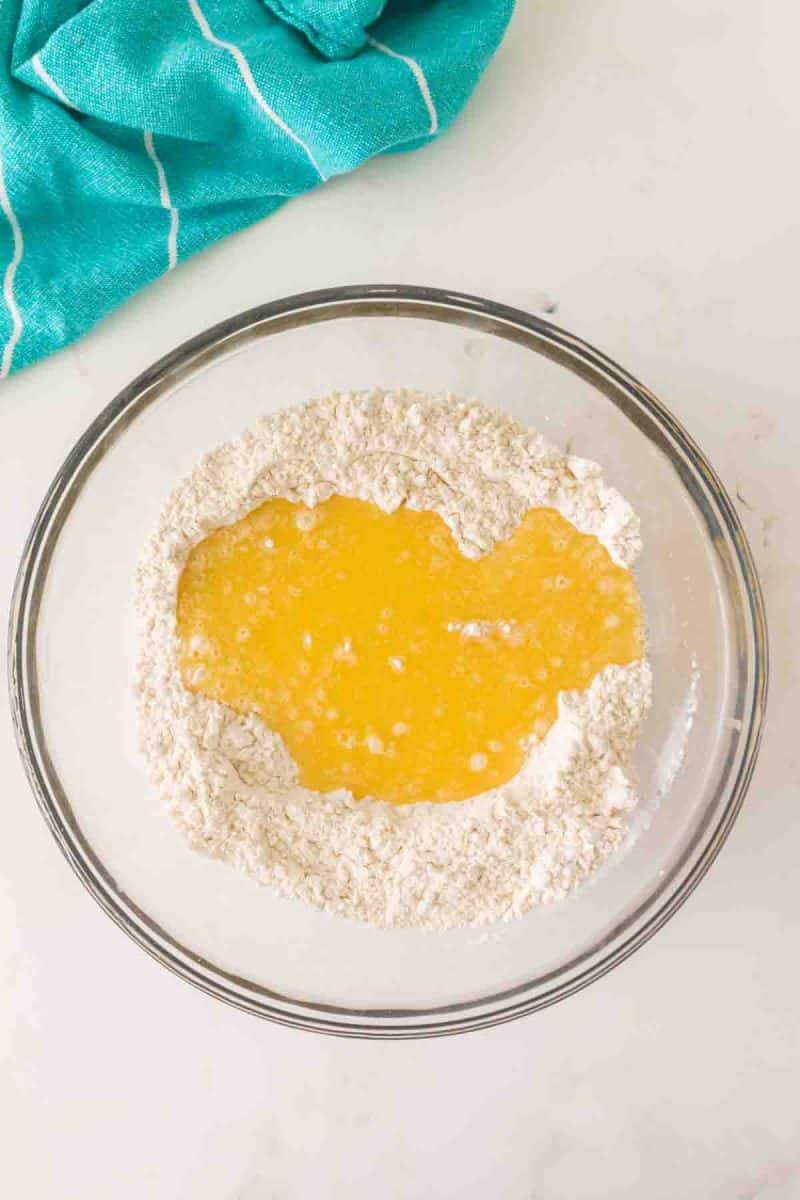 Wet ingredients added to a mixing bowl filled with Hawaiian rolls dry ingredients before mixing - Hostess At Heart