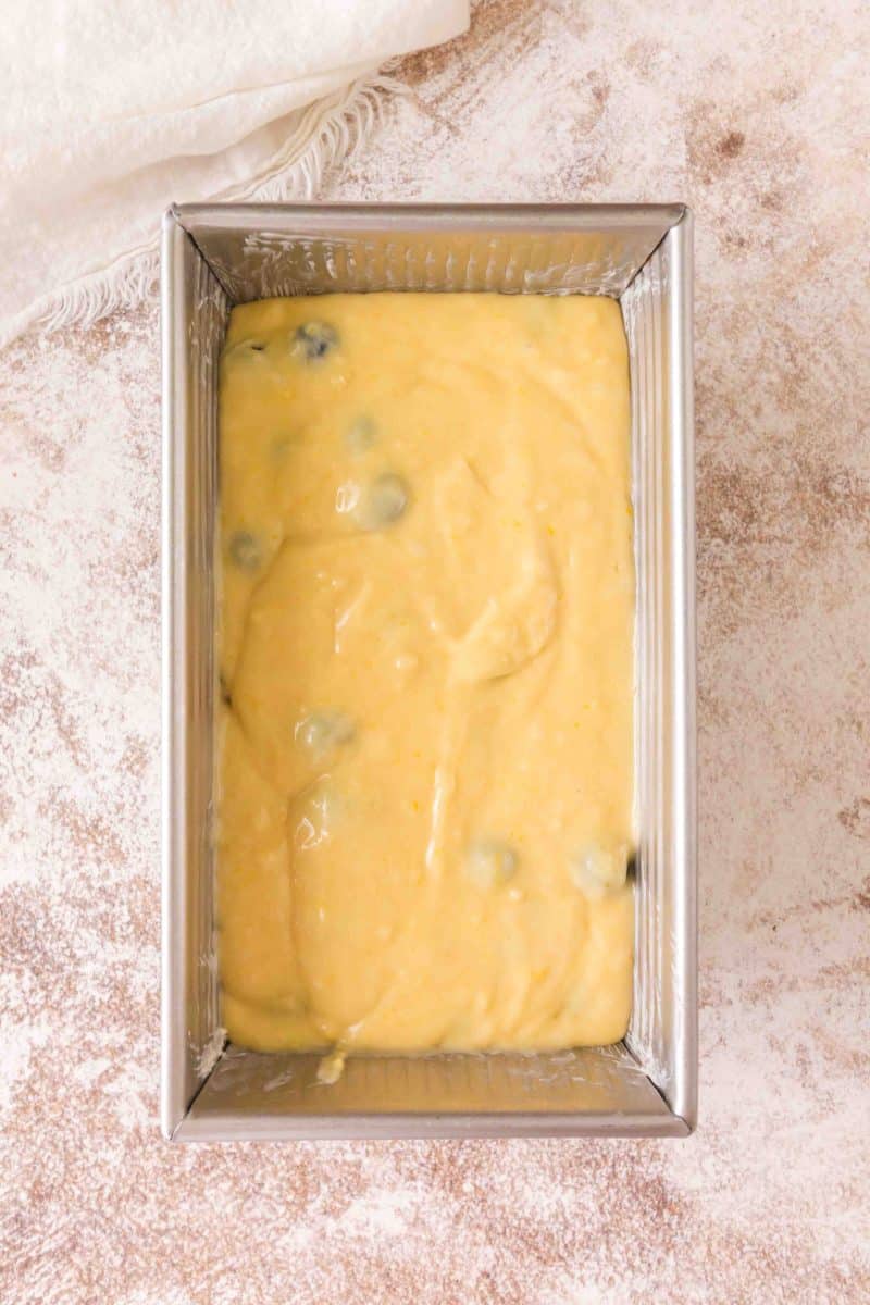 Raw lemon blueberry sourdough bread batter in loaf pan ready to bake. Hostess At Heart
