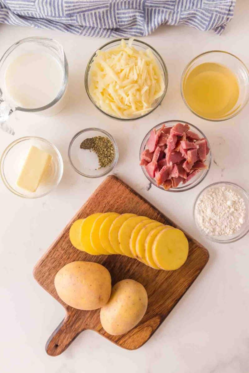 Ingredients to make Scalloped Potatoes with Ham: Gold potatoes, mozzarella cheese, salt, pepper, milk, flour, leftover cooked ham, chicken stock, butter and milk - Hostess At Heart