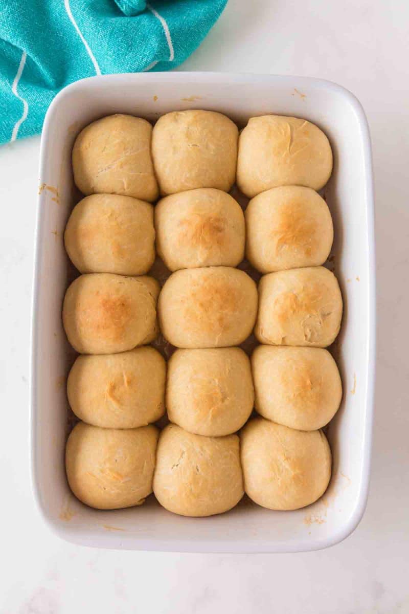 Golden brown homemade hawaiian rolls fresh from the oven in a baking dish - Hostess At Heart