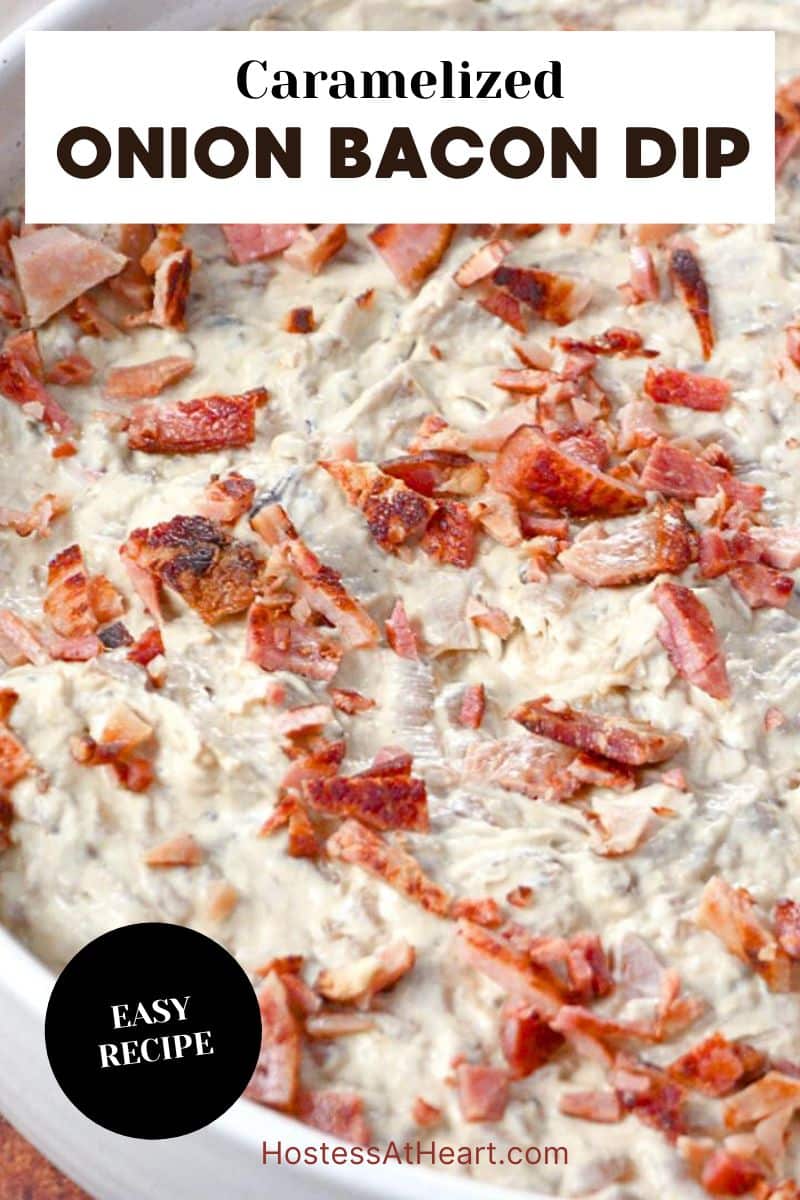 An image for Pinterest of creamy caramelized onion bacon dip topped with crispy bacon pieces in white serving bowl. Hostess At Heart