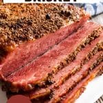 Angled view of a baked corned beef brisket that's been partially sliced. Hostess At Heart