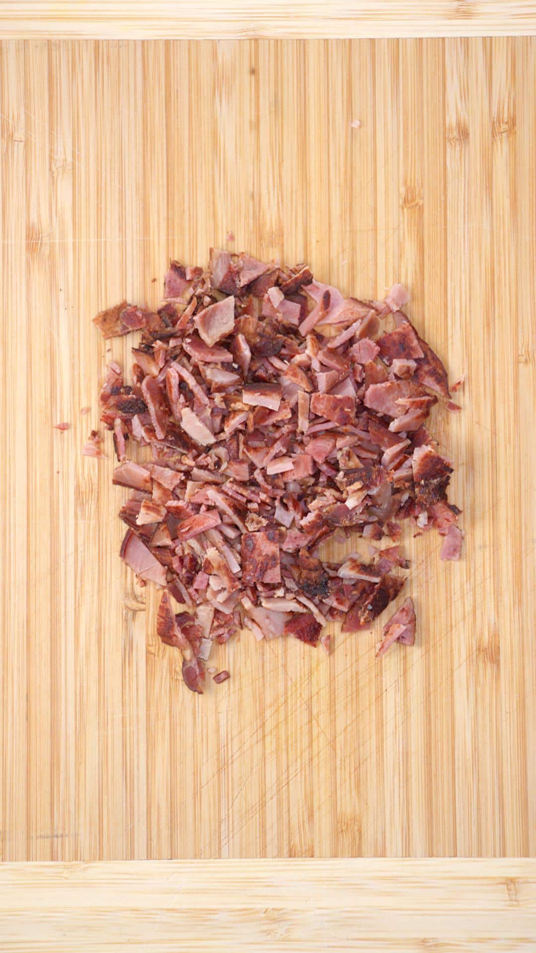 Chopped Canadian bacon on a cutting board. Hostess At Heart
