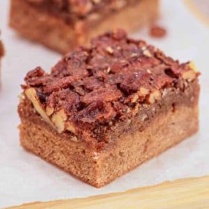 Tableview of Derby pie brownie with chocolate chips and pecans on parchment paper - Kentucky Derby Pie Dessert - Hostess At Heart