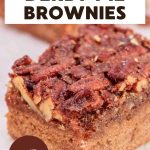 An image for Pinterest of a piece of Kentucky Derby Pie Brownie showing pecan topping layer on parchment paper - Hostess At Heart