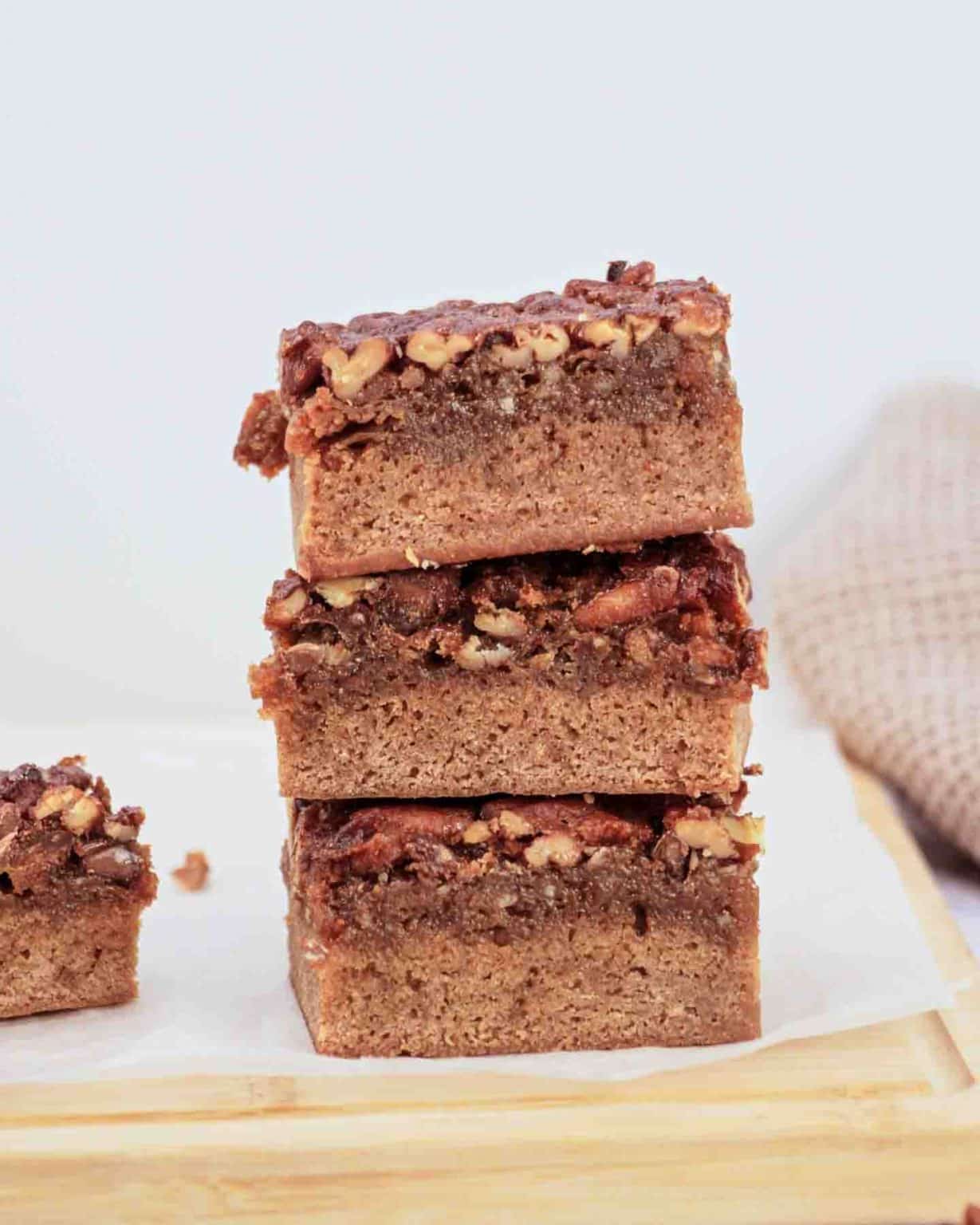 Derby pie brownies with chocolate chips and pecans on parchment paper - Kentucky Derby desserts - Hostess At Heart