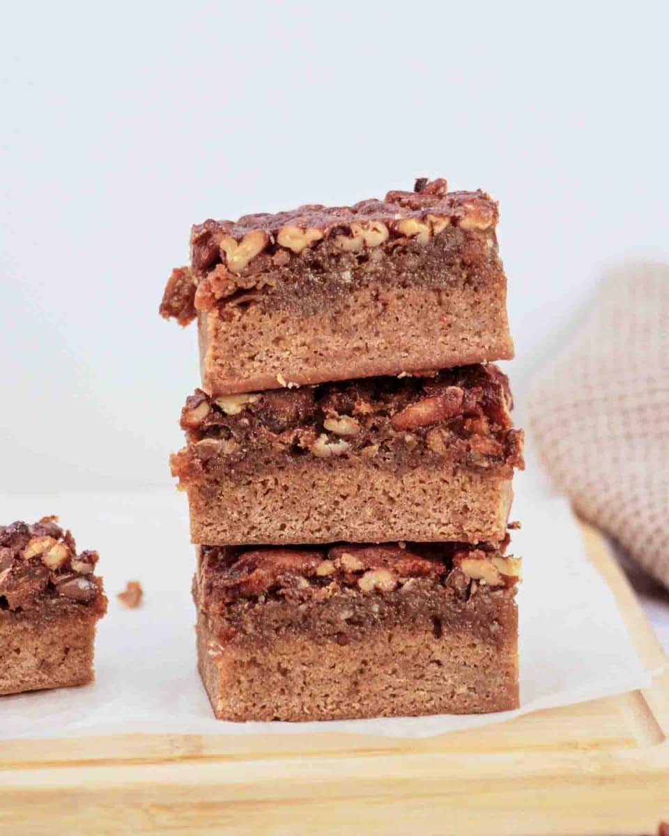 Derby pie brownies with chocolate chips and pecans on parchment paper - Kentucky Derby desserts - Hostess At Heart