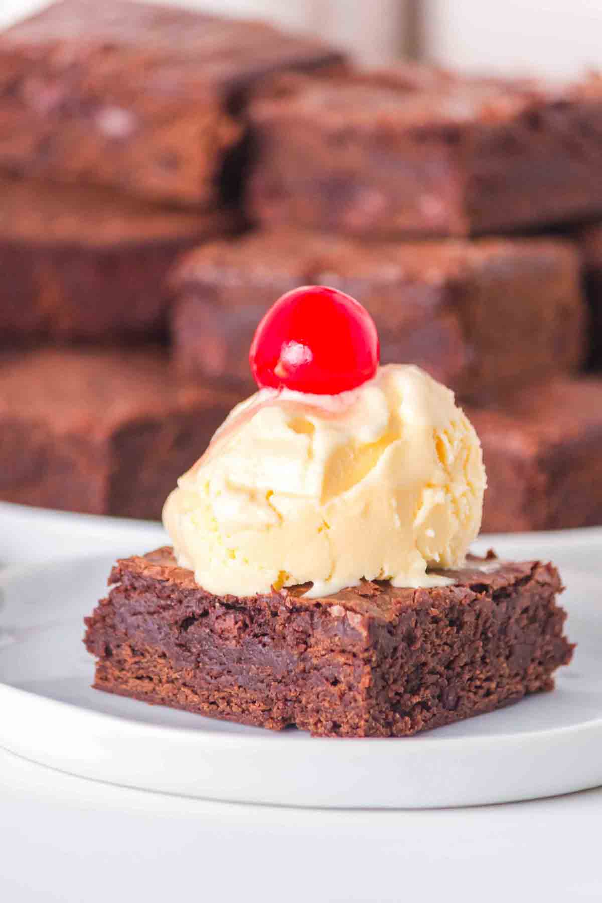 Single sourdough brownie with discard square with vanilla ice cream and a cherry for Valentine's Day. Hostess At Heart
