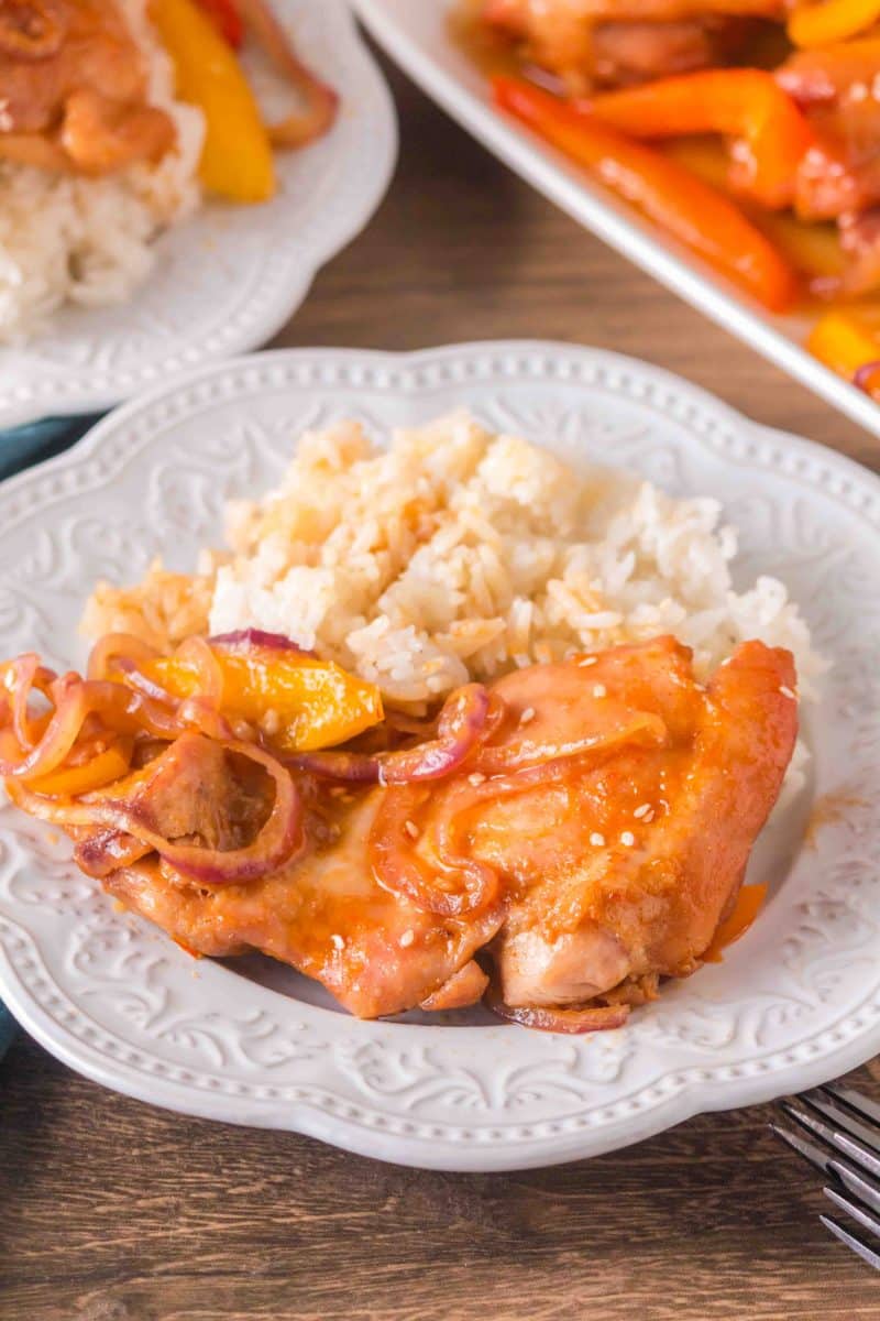 Plated honey garlic chicken thigh and vegetables next to white rice - Hostess At Heart