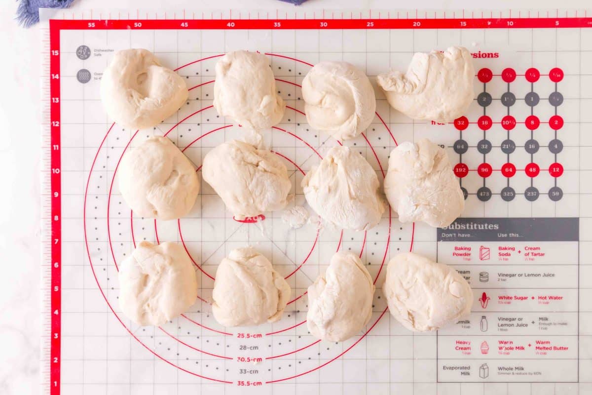 Risen bagel dough cut into 12 pieces for homemade bagels - Hostess At Heart