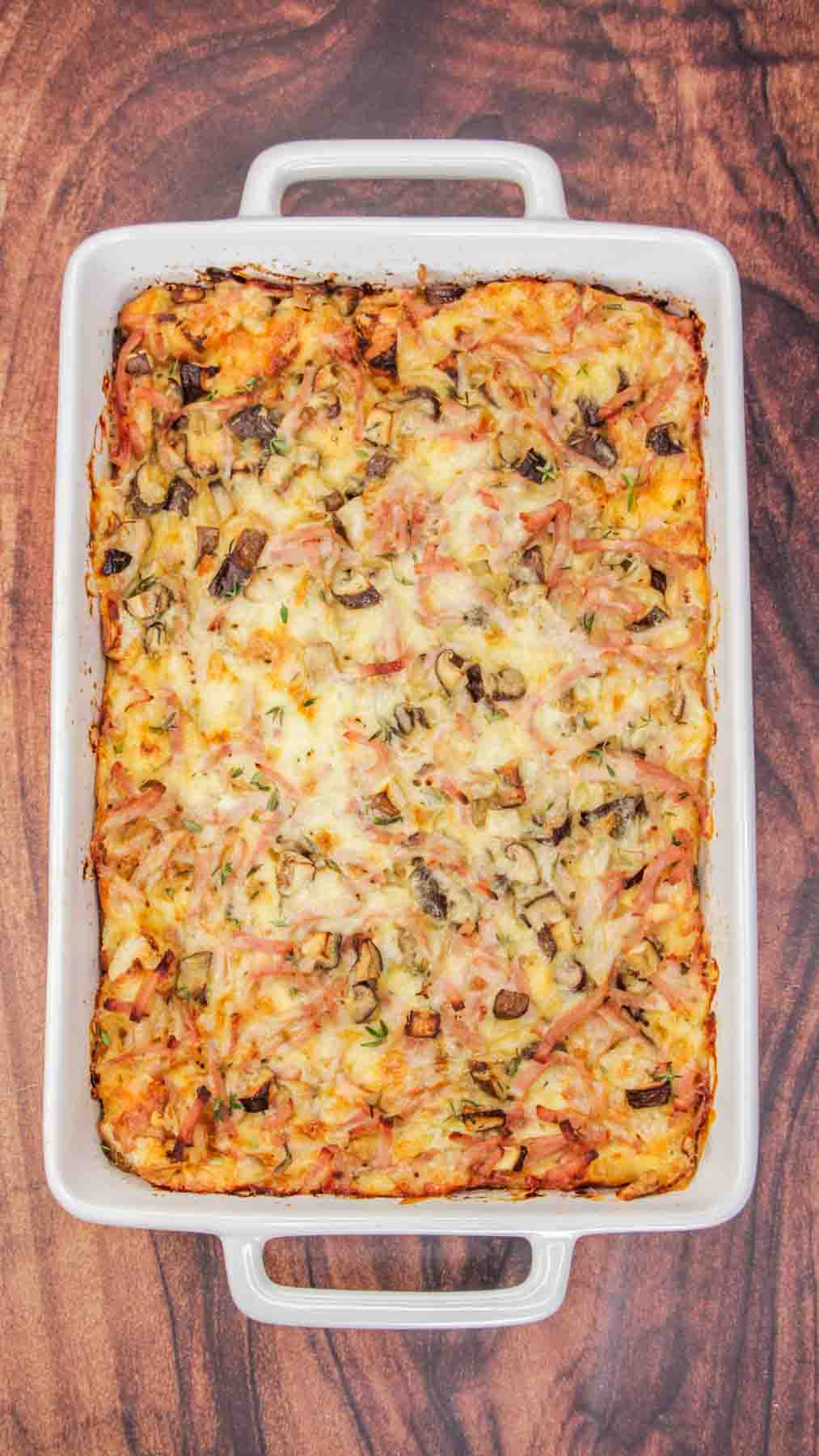 Golden brown ham and cheese mushroom breakfast strata fresh from the oven in white baking dish. Hostess At Heart