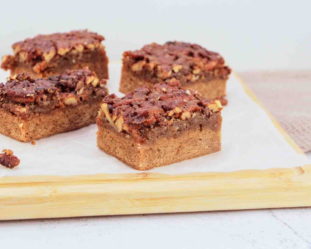Close up of cut pieces of fudgy bourbon brownie layer with pecan pie topping - Hostess At Heart