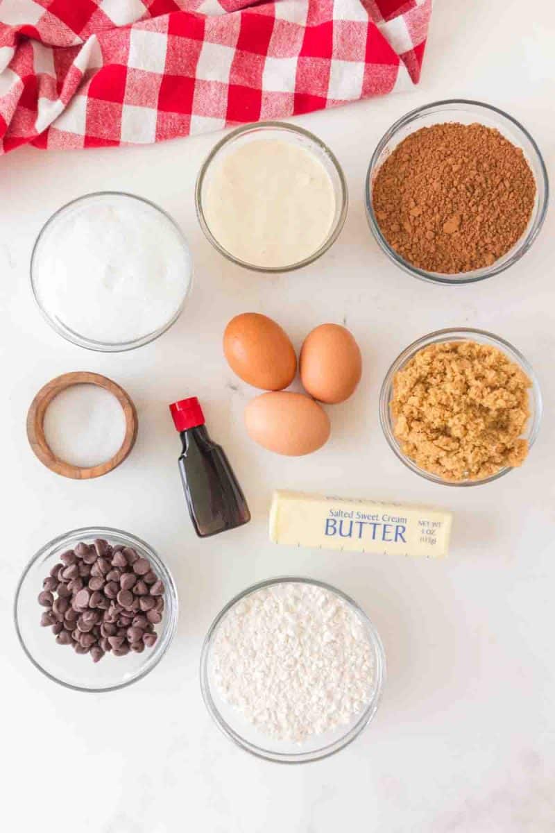 Ingredients to make Chocolate Sourdough Brownies: flour, butter, chocolate chips, white and brown sugar, vanilla extract, eggs, cocoa, sourdough discard, and salt. Hostess At Heart