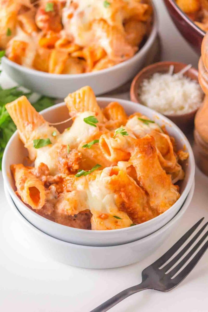 A bowl filled with baked rigatoni with 3 cheeses melted into a creamy filling and sausage. Hostess At Heart