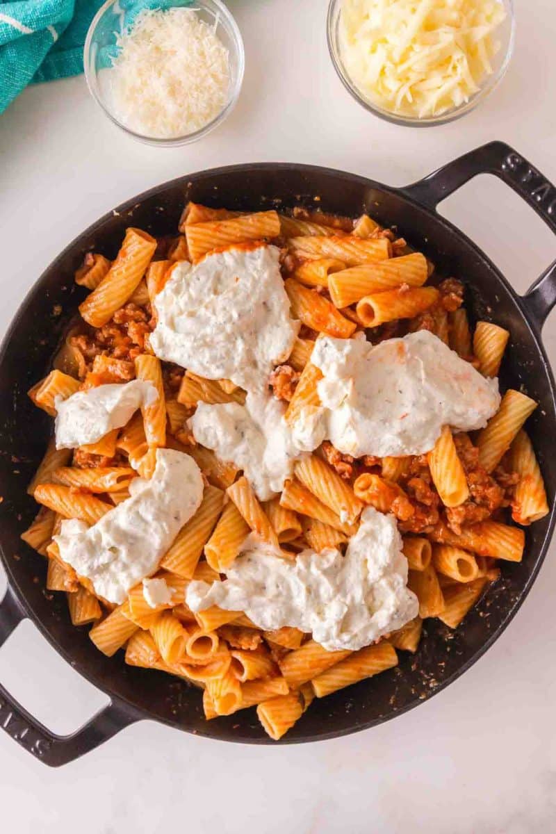 Adding ricotta mixture to baked rigatoni before baking. Hostess At Heart