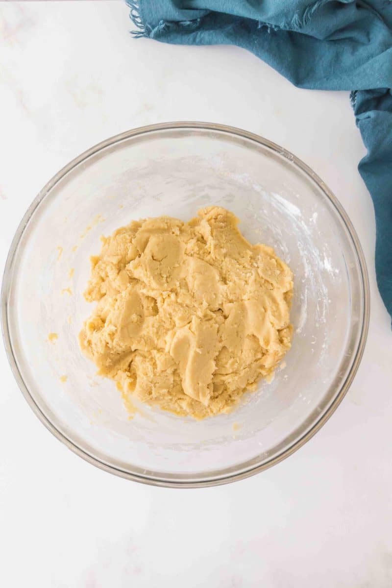 A mixing bowl filled with cherry pie bar dough waiting to be spread into a baking dish. Hostess At Heart