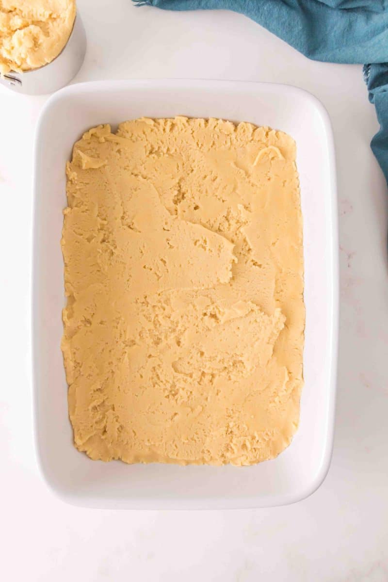 Overhead view of Cherry Bar dough spread over the bottom of a 9x13 pan. Hostess At Heart