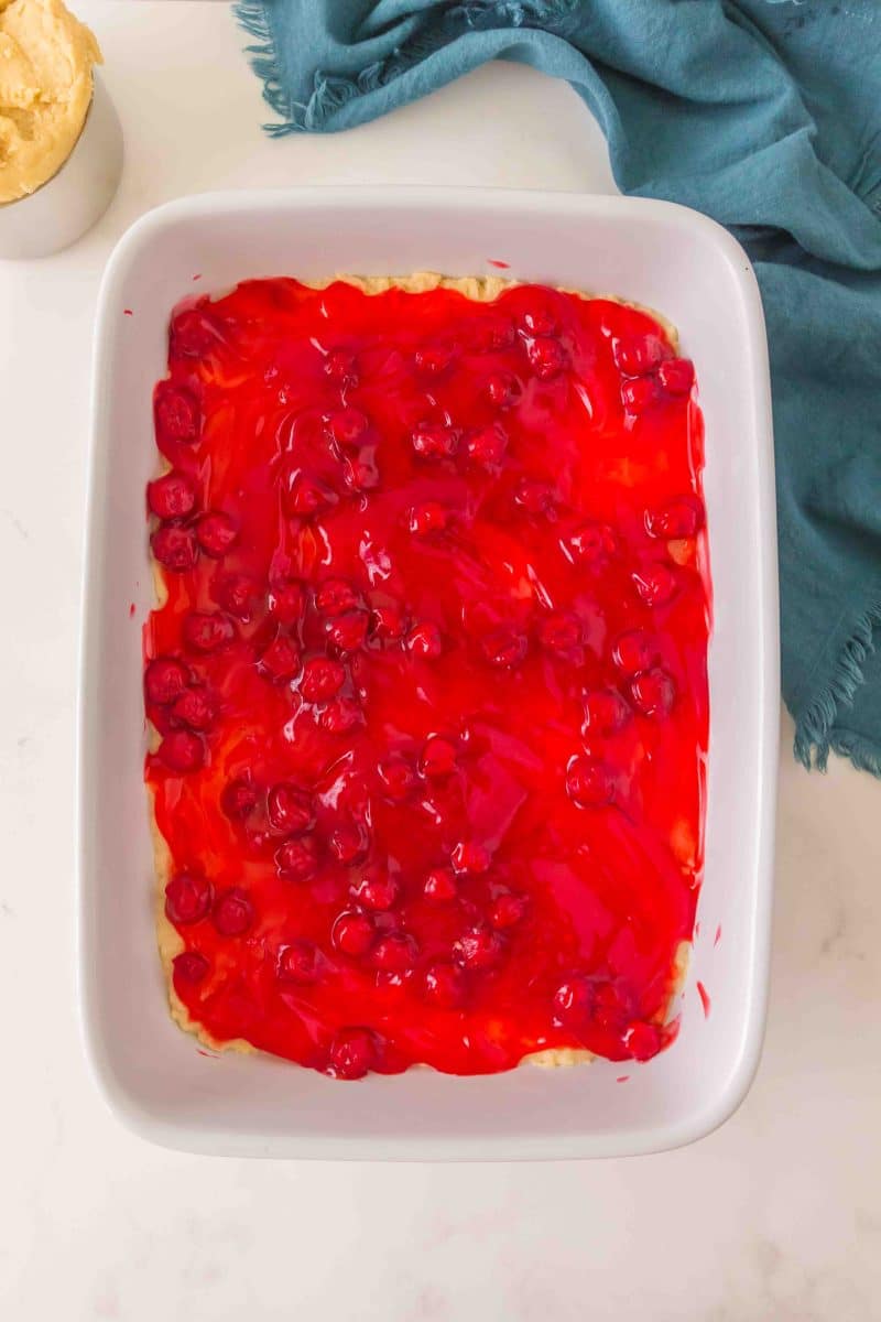 A layer of cherry pie filling over baked crust in 9x13 pan. Hostess At Heart