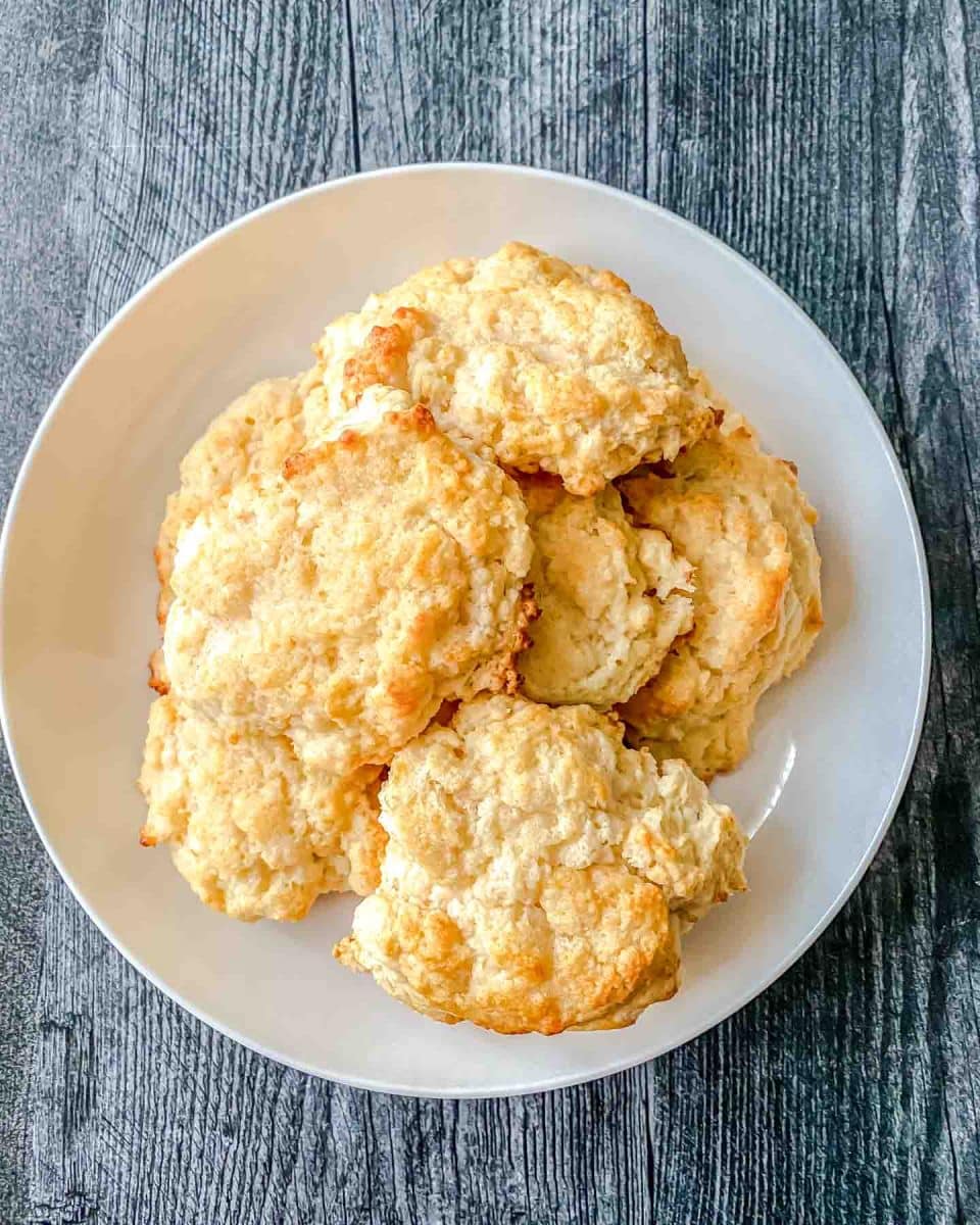 Top down view of a serving dish filled with freshly baked honey butter biscuits recipe from scratch - Hostess At Heart