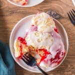 A spoonful of Cherry Pie Bar on a plate with a fork, showing the buttery layers. Hostess At Heart